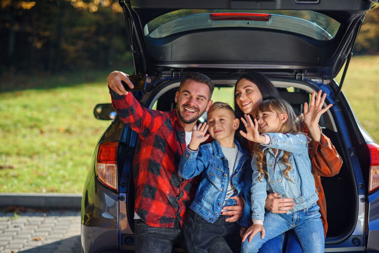 happy stylish parents witewhile sitting trunk 768x513