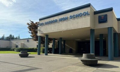 Gig Harbor High School entrance with blue columns and circular concrete planters on a sunny day