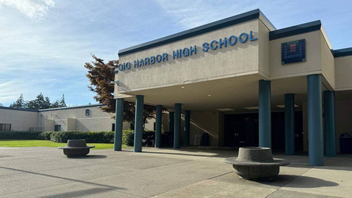 Gig Harbor High School entrance with blue columns and circular concrete planters on a sunny day