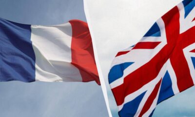 French flag and UK flag fluttering in the wind, separated by a white seam. (informative)