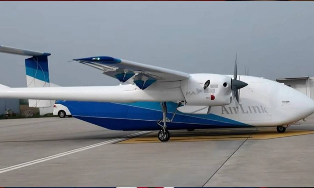 Small white and blue AirLink aircraft parked on a taxiway, showing a high-wing design and front propeller.