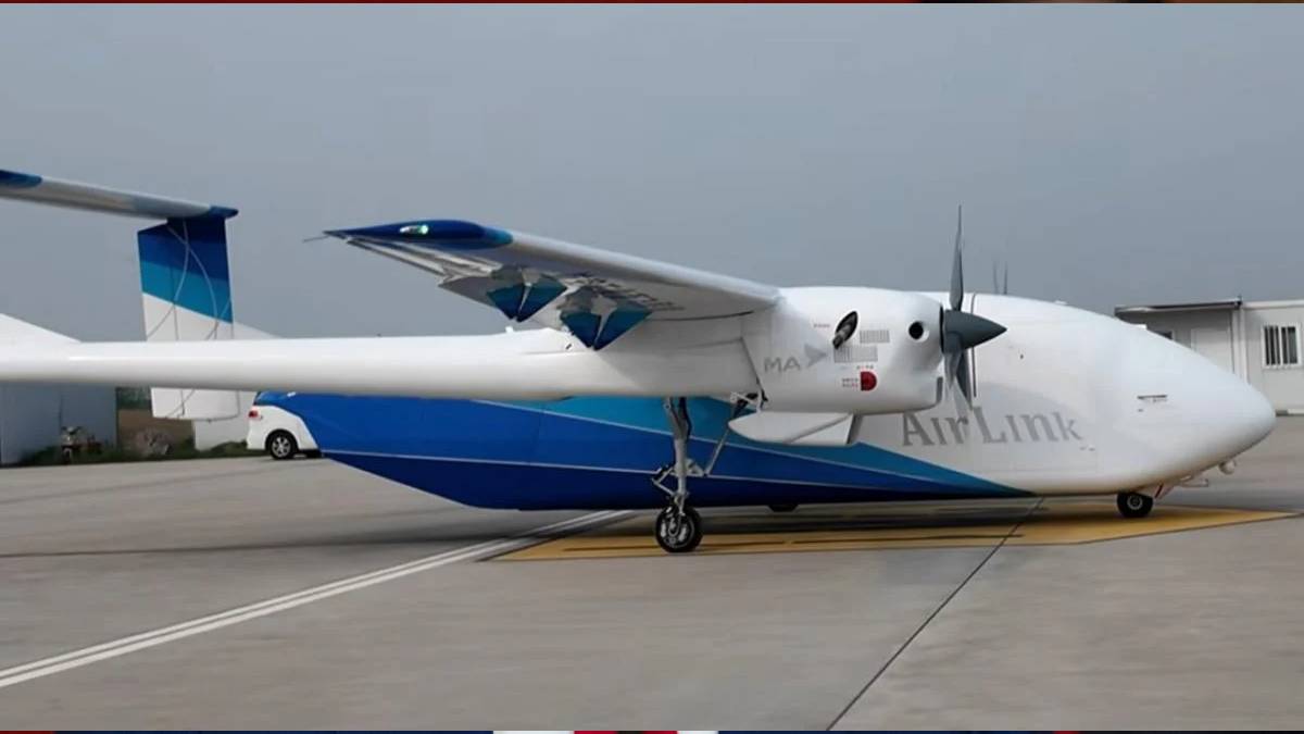 Small white and blue AirLink aircraft parked on a taxiway, showing a high-wing design and front propeller.