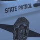 White state patrol vehicle door with 'STATE PATROL' text and the Washington State Patrol badge next to it? on the door emblem