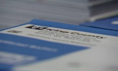 Close-up of blue packaging with a white label and dark logo, text is out of focus.