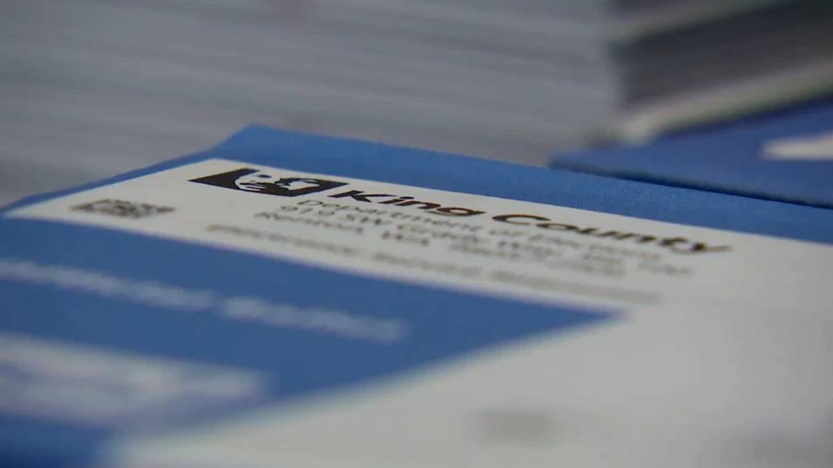 Close-up of blue packaging with a white label and dark logo, text is out of focus.