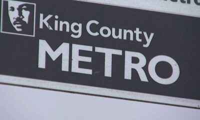 King County METRO sign with a square portrait logo on the left and bold METRO text on a dark background.