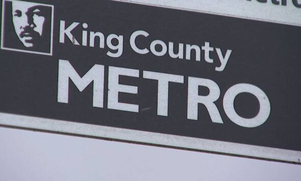 King County METRO sign with a square portrait logo on the left and bold METRO text on a dark background.