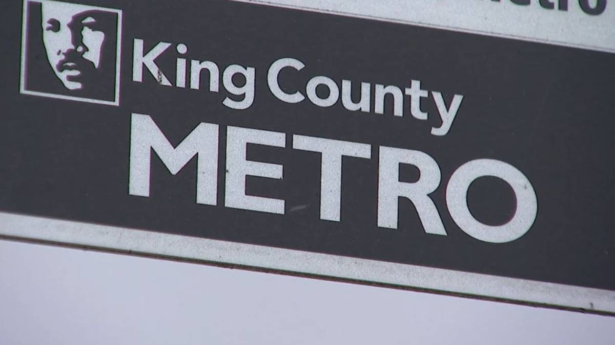 King County METRO sign with a square portrait logo on the left and bold METRO text on a dark background.