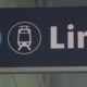 Sign showing the number 2 and a tram icon with the word 'Link' on a dark background, indicating a transit line