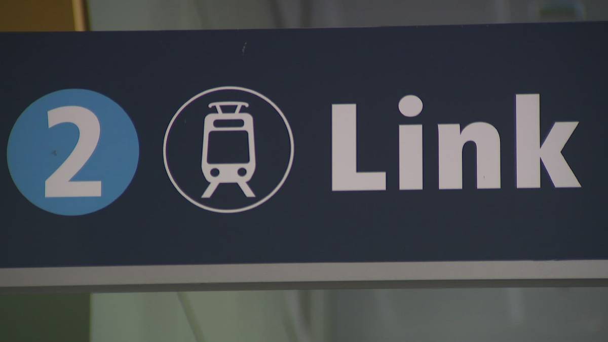 Sign showing the number 2 and a tram icon with the word 'Link' on a dark background, indicating a transit line