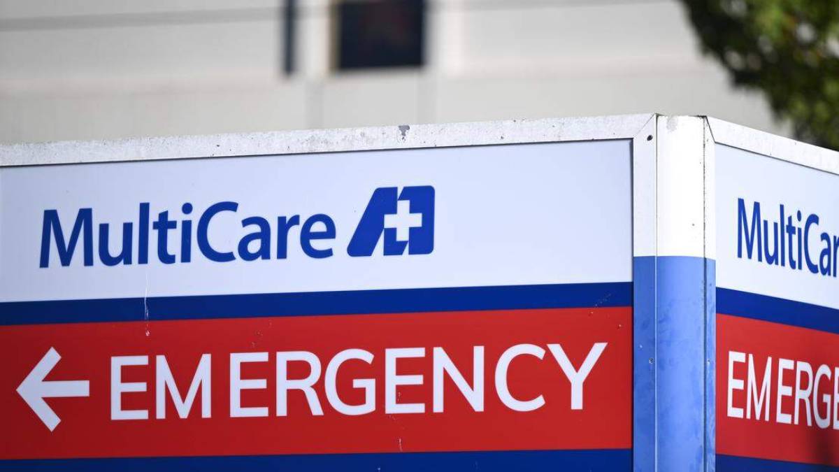 Emergency department sign featuring MultiCare branding, with a red banner reading 'EMERGENCY' and a white arrow nearby.