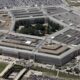 Aerial view of the U.S. Pentagon building with its distinctive five-sided shape and central courtyard, seen from above.