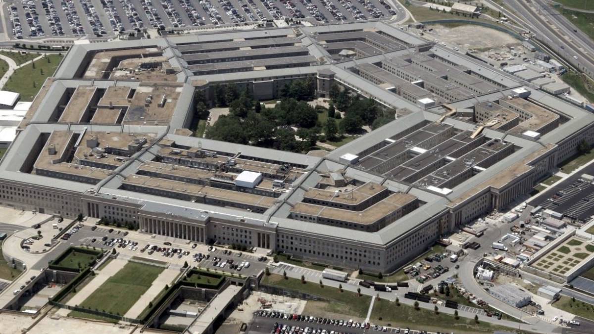 Aerial view of the U.S. Pentagon building with its distinctive five-sided shape and central courtyard, seen from above.