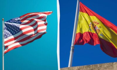 Split image showing the American flag on the left and the Spanish flag on the right against blue skies, separated by a white divider.