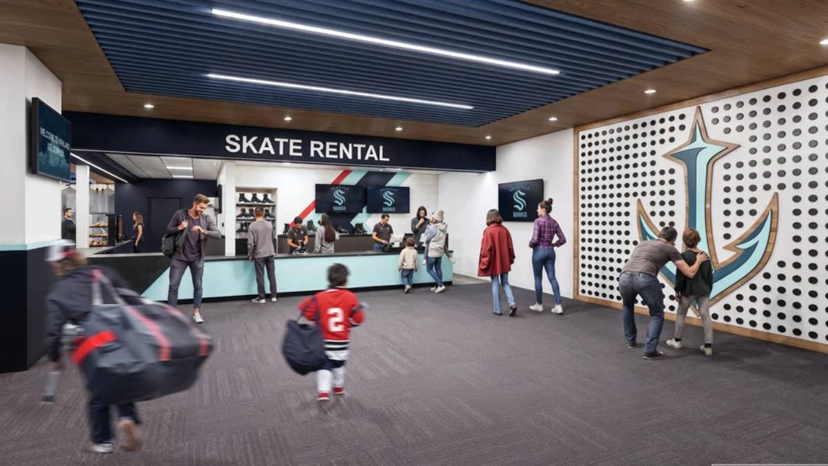 Skate rental counter in a modern lobby with customers queuing and a child walking away.