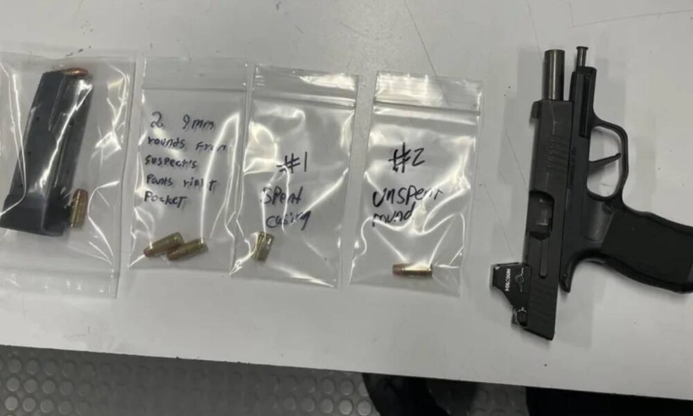 Semi-automatic handgun with a spare magazine on a table, next to three small resealable bags containing bullets and handwritten notes on each bag (evidence layout).