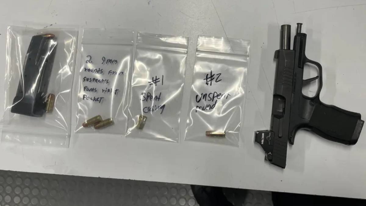 Semi-automatic handgun with a spare magazine on a table, next to three small resealable bags containing bullets and handwritten notes on each bag (evidence layout).