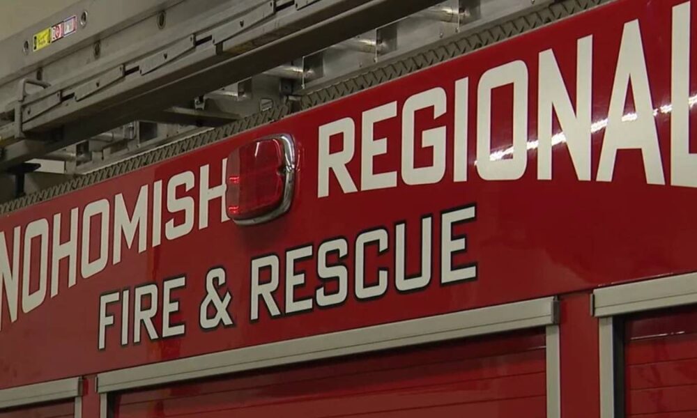 Red fire department vehicle side with white 'Snohomish Regional Fire & Rescue' lettering and a small emergency light above.