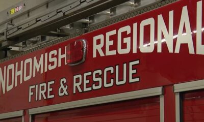 Red fire department vehicle side with white 'Snohomish Regional Fire & Rescue' lettering and a small emergency light above.