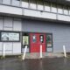 Front of the Tacoma Historical Society building with red double doors and a sign reading 'Tacoma Historical Society' beside the entrance.
