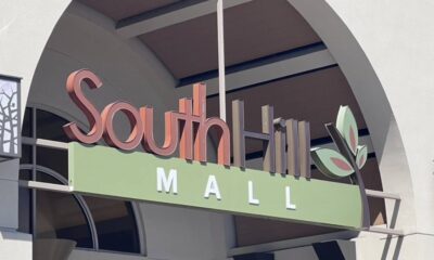 Sign reading SouthHill Mall with a green panel and leaf logo at an outdoor entrance. May be used for mall or shopping center context.