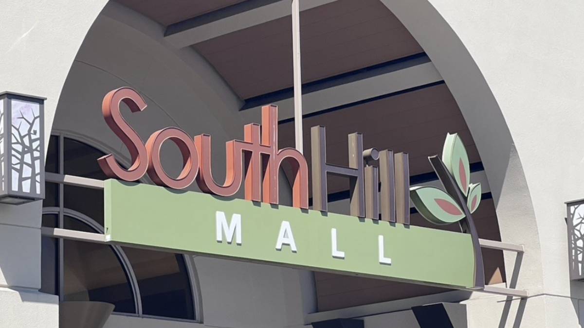 Sign reading SouthHill Mall with a green panel and leaf logo at an outdoor entrance. May be used for mall or shopping center context.