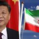 Portrait of Xi Jinping on the left with a Chinese flag behind him, and the Iran flag waving on the right against a blue sky.