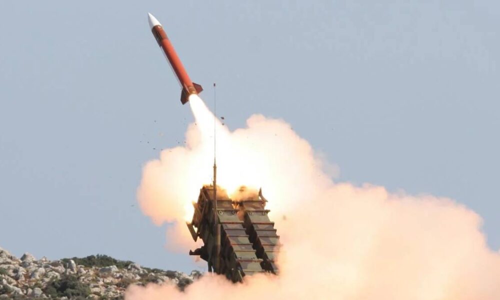 Red missile lifting off from a mobile launcher, with a large smoke plume behind it.