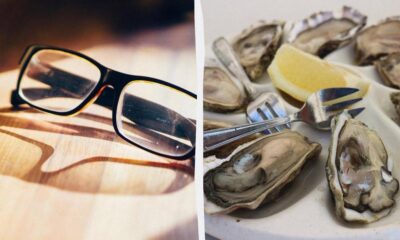 Split image: left shows black-rimmed glasses on a wooden surface; right shows a plate with oysters, lemon wedge, and forks.