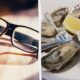 Split image: left shows black-rimmed glasses on a wooden surface; right shows a plate with oysters, lemon wedge, and forks.