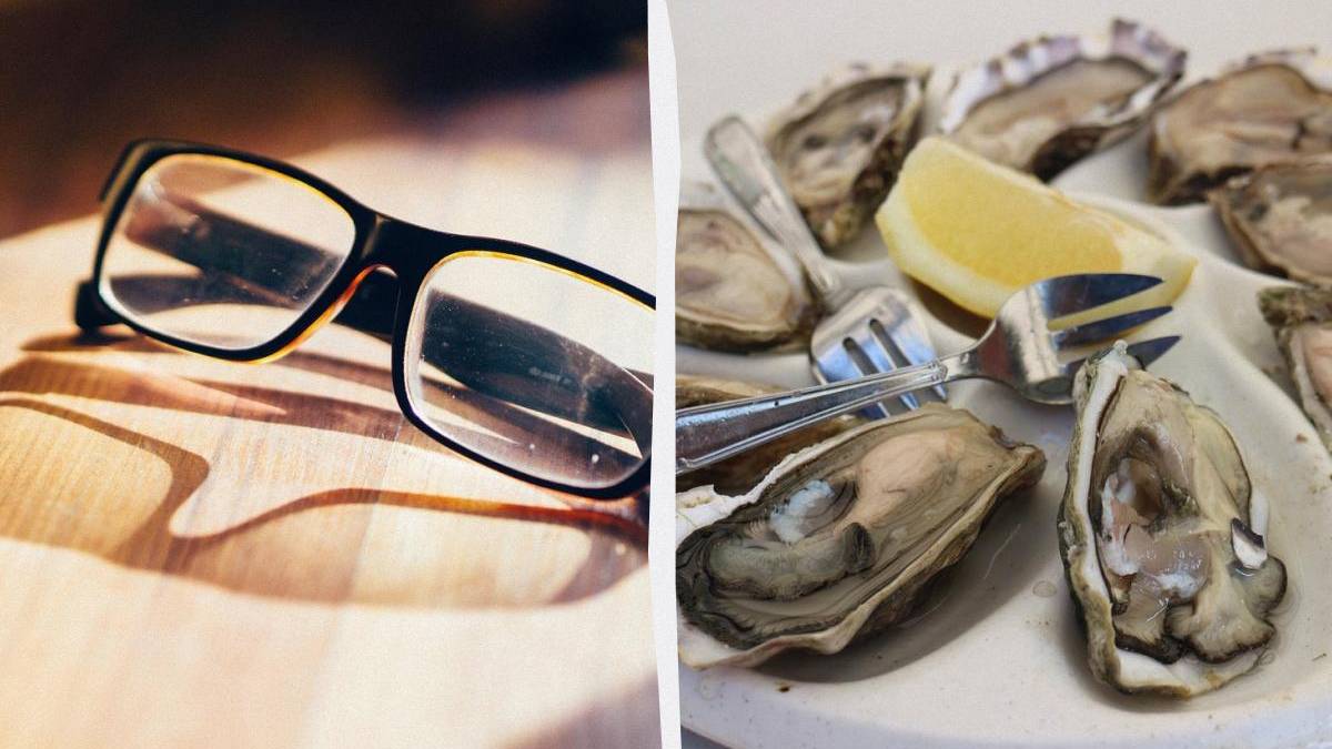 Split image: left shows black-rimmed glasses on a wooden surface; right shows a plate with oysters, lemon wedge, and forks.