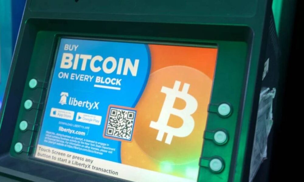 Bitcoin ATM screen advertising Bitcoin purchase with a large Bitcoin logo and colorful display.