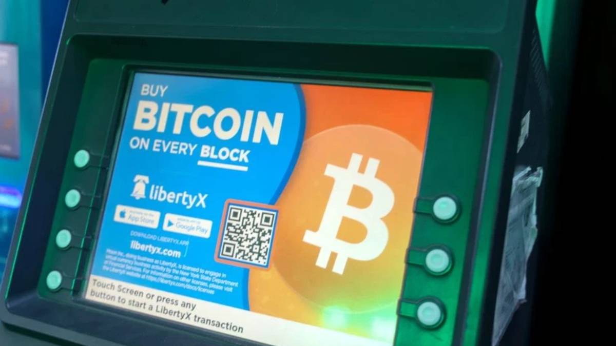 Bitcoin ATM screen advertising Bitcoin purchase with a large Bitcoin logo and colorful display.