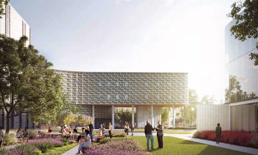 Modern urban courtyard with a curved, perforated building facade and people sitting at tables among flowering plants.