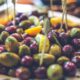 Plate of mixed olives on skewers with lemon wedges, a tapas-style appetizer area.