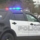 Bellevue Police SUV with blue and red emergency lights flashing, side view