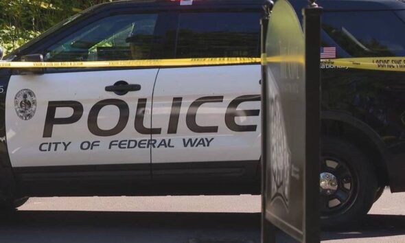 City of Federal Way police SUV with yellow caution tape across the side, cordoning off the area.