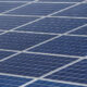 Close-up of blue photovoltaic solar panels arranged in a grid.