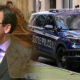 Man in a suit speaks at a podium with a transparent shield as a Seattle Police SUV sits parked on a city street in the background.