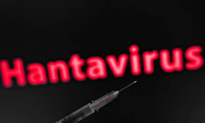 Syringe in the foreground with blurred red 'Hantavirus' text in the dark background, suggesting a health risk or vaccine topic.