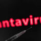 Syringe in the foreground with blurred red 'Hantavirus' text in the dark background, suggesting a health risk or vaccine topic.