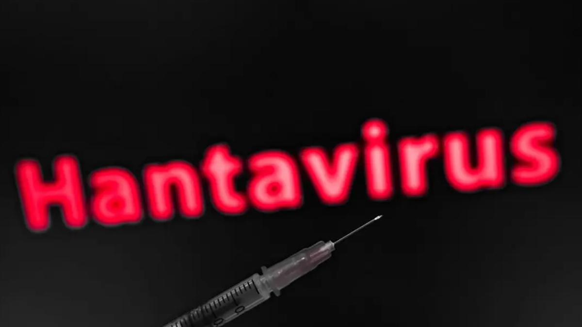 Syringe in the foreground with blurred red 'Hantavirus' text in the dark background, suggesting a health risk or vaccine topic.
