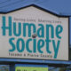 Sign for the Humane Society Tacoma & Pierce County with the slogan Saving Lives. Sharing Lives.
