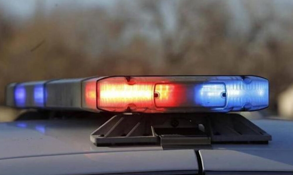 Close-up of red and blue emergency lights on top of a police car, flashing.