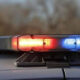 Close-up of red and blue emergency lights on top of a police car, flashing.