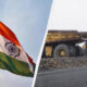 Split image: Indian flag waving on the left and a line of yellow mining dump trucks on a rocky road on the right, highlighting contrast between nation and industry.