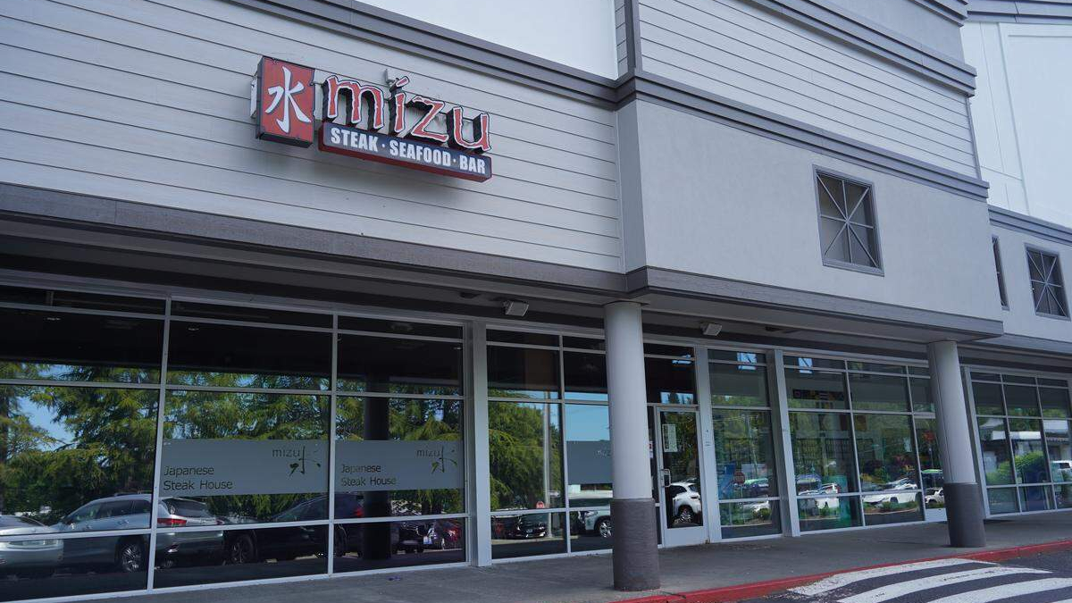 Exterior of Mizui restaurant storefront with sign reading Mizui and 'Steak · Seafood · Bar' above large glass windows