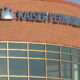 Facade of a Kaiser Permanente medical building with a brick exterior and large glass windows beneath a curved wall.