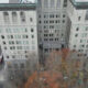 Aerial view of a large pale stone building with a central entrance, surrounded by a courtyard and autumn-colored trees; city streets and other buildings visible nearby.