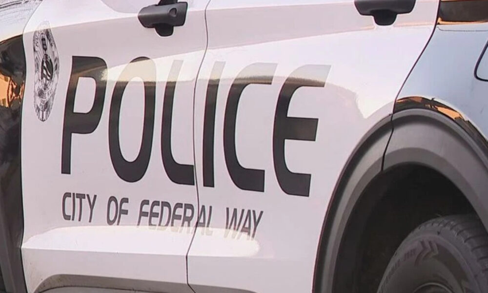 Side view of a white police SUV with large 'POLICE' lettering and 'City of Federal Way' on the door.